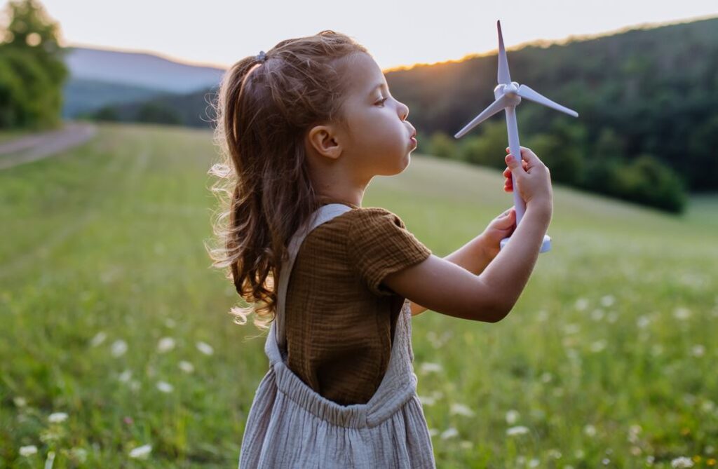 Image of young girl with wind farm windmill